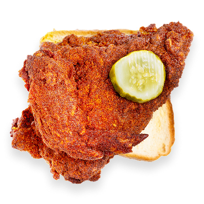 Crispy seasoned fried chicken thigh on a square of white sandwich bread topped with a dill pickle slice.
